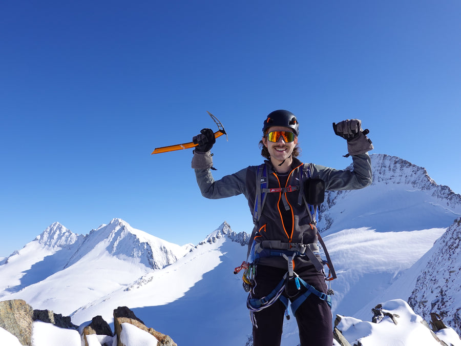 Leo Aschberger, LANK Technology co-founder, on a mountain summit with an ice axe